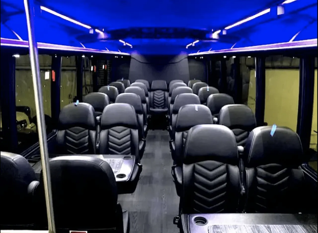 Ford Mini-Coach, the inside featuring passenger tables, cup holders and LED ceiling lighting