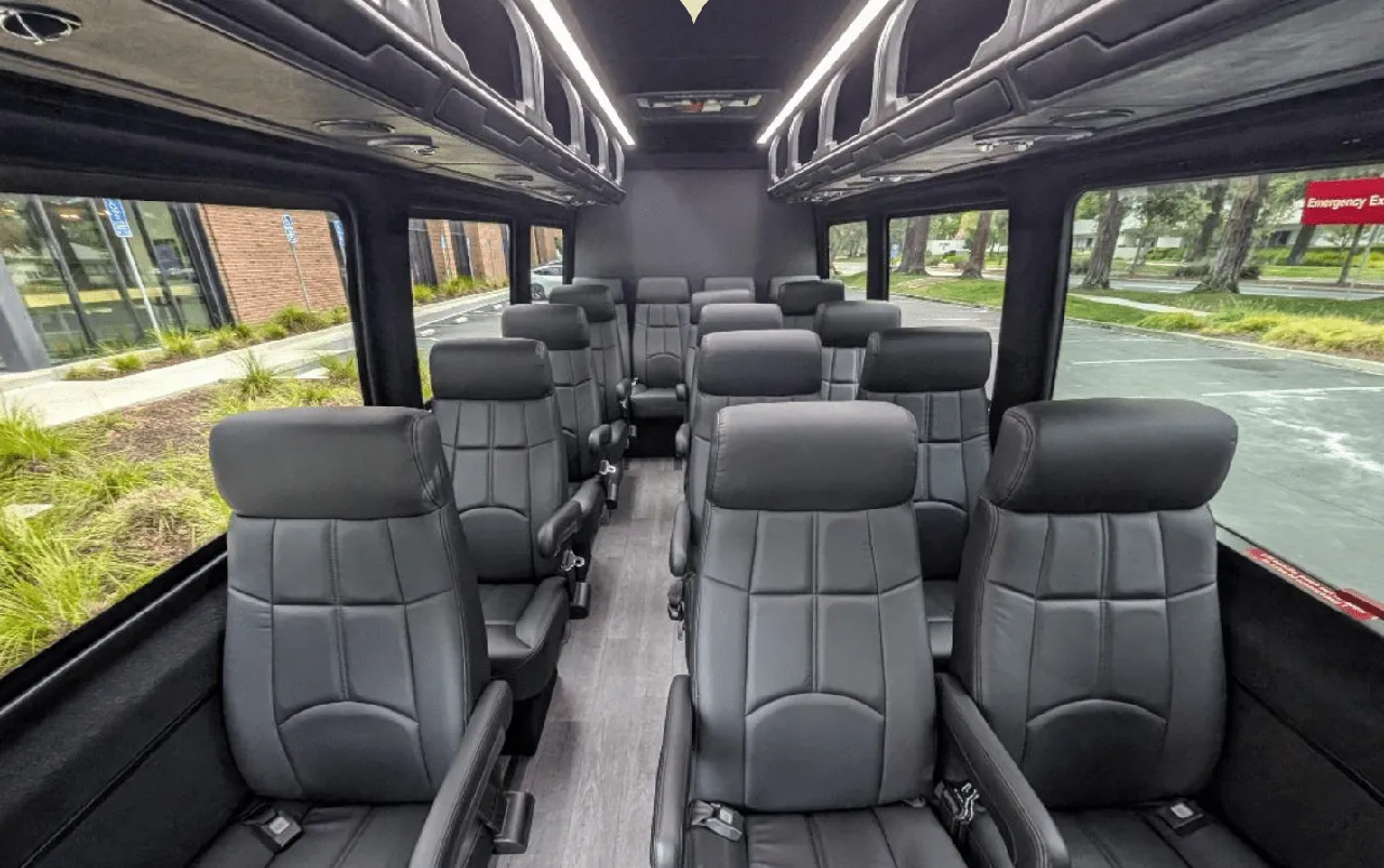 Mercedes-Benz Executive Sprinter, the inside featuring captain's chairs, wood-look flooring and overhead parcel racks