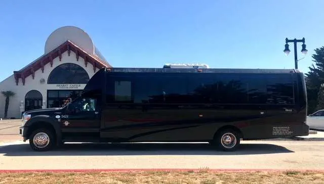 28 Passenger Mini Coach (black) featuring tinted windows