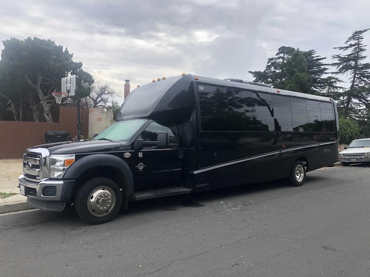 21 Passenger Mini Coach (black) featuring tinted windows