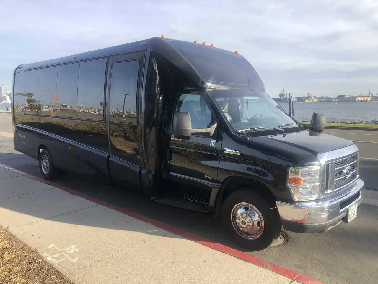 21 Passenger Mini Coach (black), outside view featuring tinted windows – picture 3
