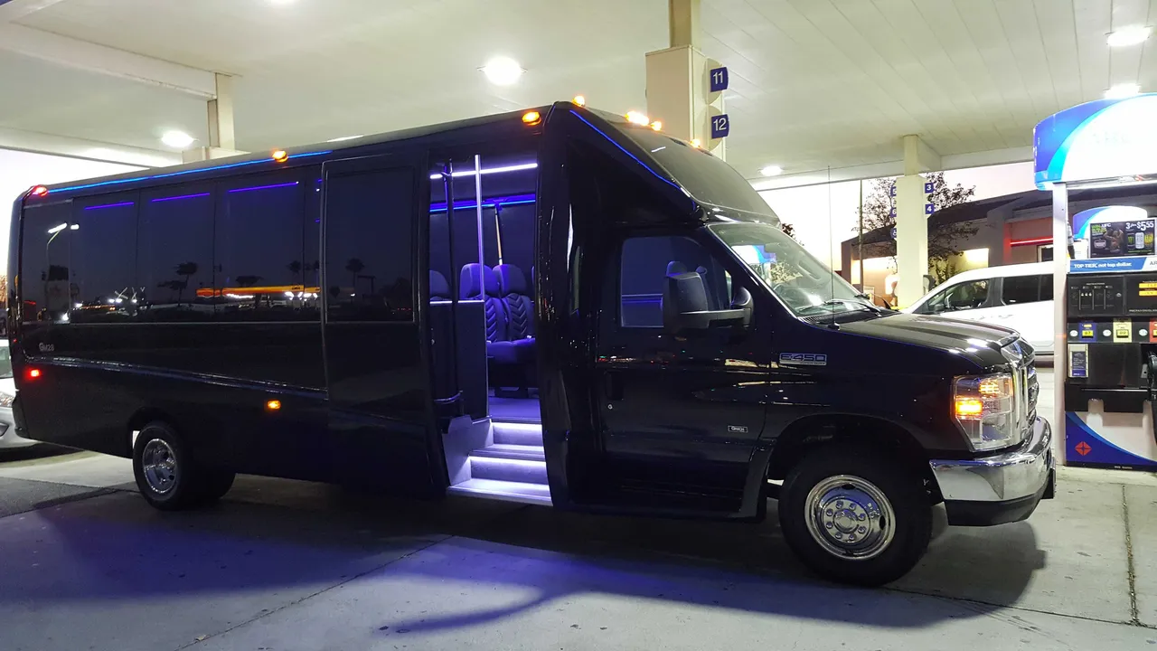 31 Passenger Mini Coach (black) featuring tinted windows and LED accent lighting