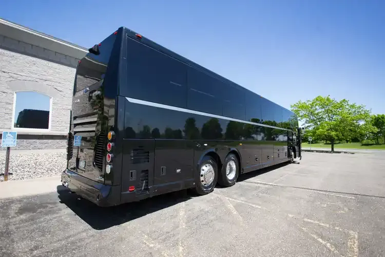 Black 56 Passenger Motorcoach with tinted windows for charter bus rental