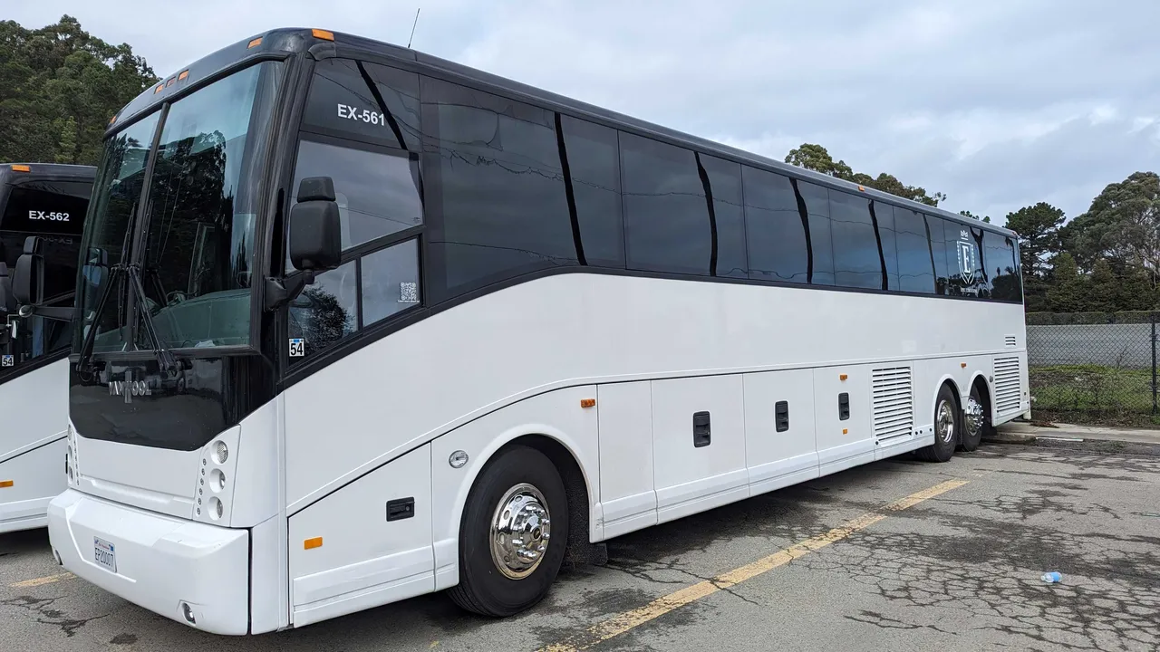 White 56 Passenger Motorcoach with tinted windows for charter bus rental