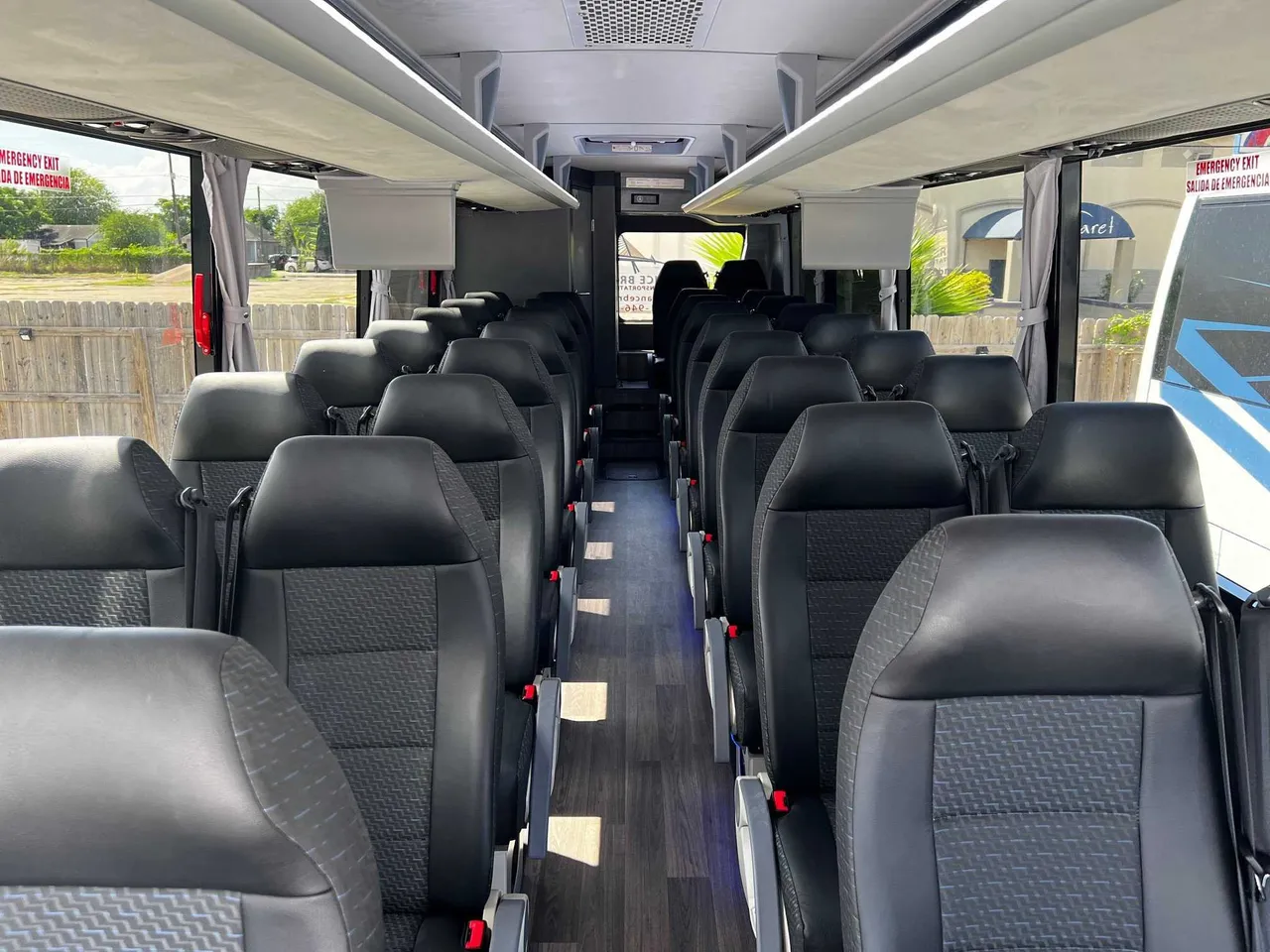 34 Passenger Charter Bus interior with window shades and overhead parcel racks for charter bus rental